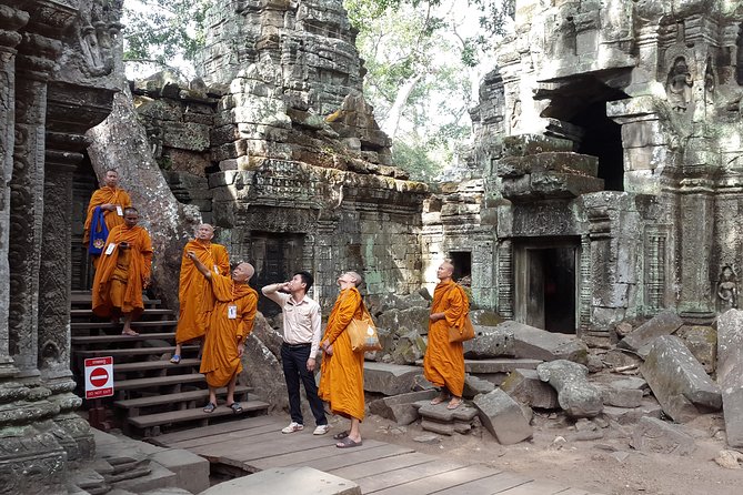 1day private tour all main temple in Angkor,sunset at TonleSap floating village - Ta Prohm and the trees over the stone