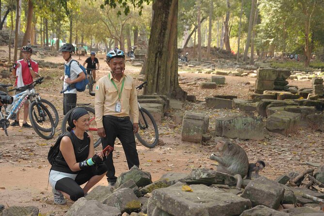 Angkor Sunrise Bike Tour with Lunch Included - Ta Prohm and the trees over the stones
