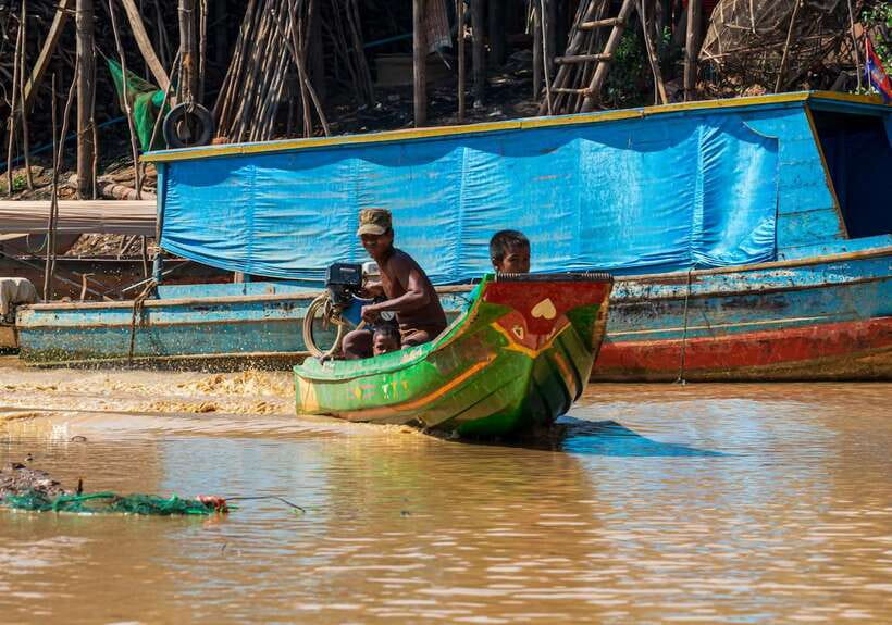 Siem Reap Floating Village Kampong Phluk Sunset with Boat - The river boat and the changing water